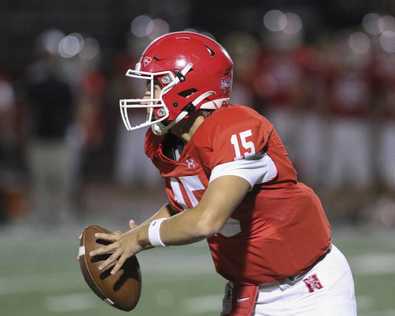 Naperville Central's Jackson Loth (15) looks for a receiver during football game between Oswego at Naperville Central  on Friday, Aug 29, 2025  in Naperville.