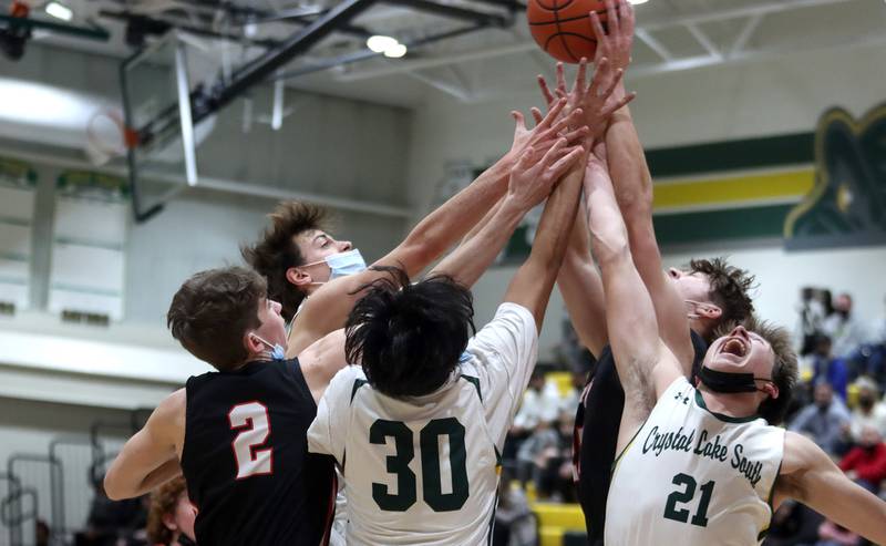 A host of Crystal Lake South and Huntley players, including Huntley’s John Kramer at left and Crystal Lake South’s Cooper LePage at right, battle for the ball in boys varsity basketball at Crystal Lake Friday night.