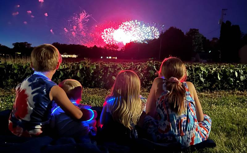 Abram, 5, Silas, 1, Adaline, 2, and Emma, 10, watch Mendota's fireworks Saturday, July 9, 2022.