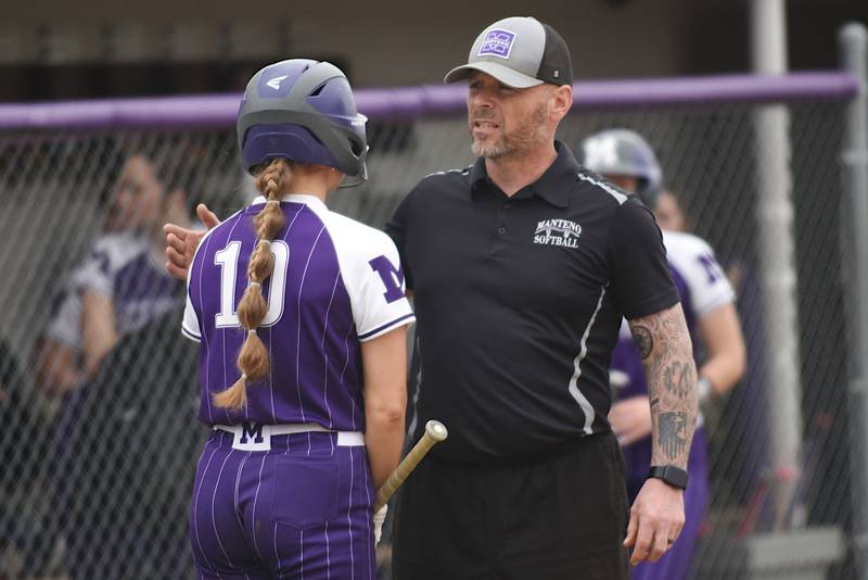 Manteno softball coach Josh Carlile, right, talks to Ayssa Singleton moments before Singleton delivered the walk-off double in the Panthers' 6-5 home win over Pontiac Friday, April 3, 2026.