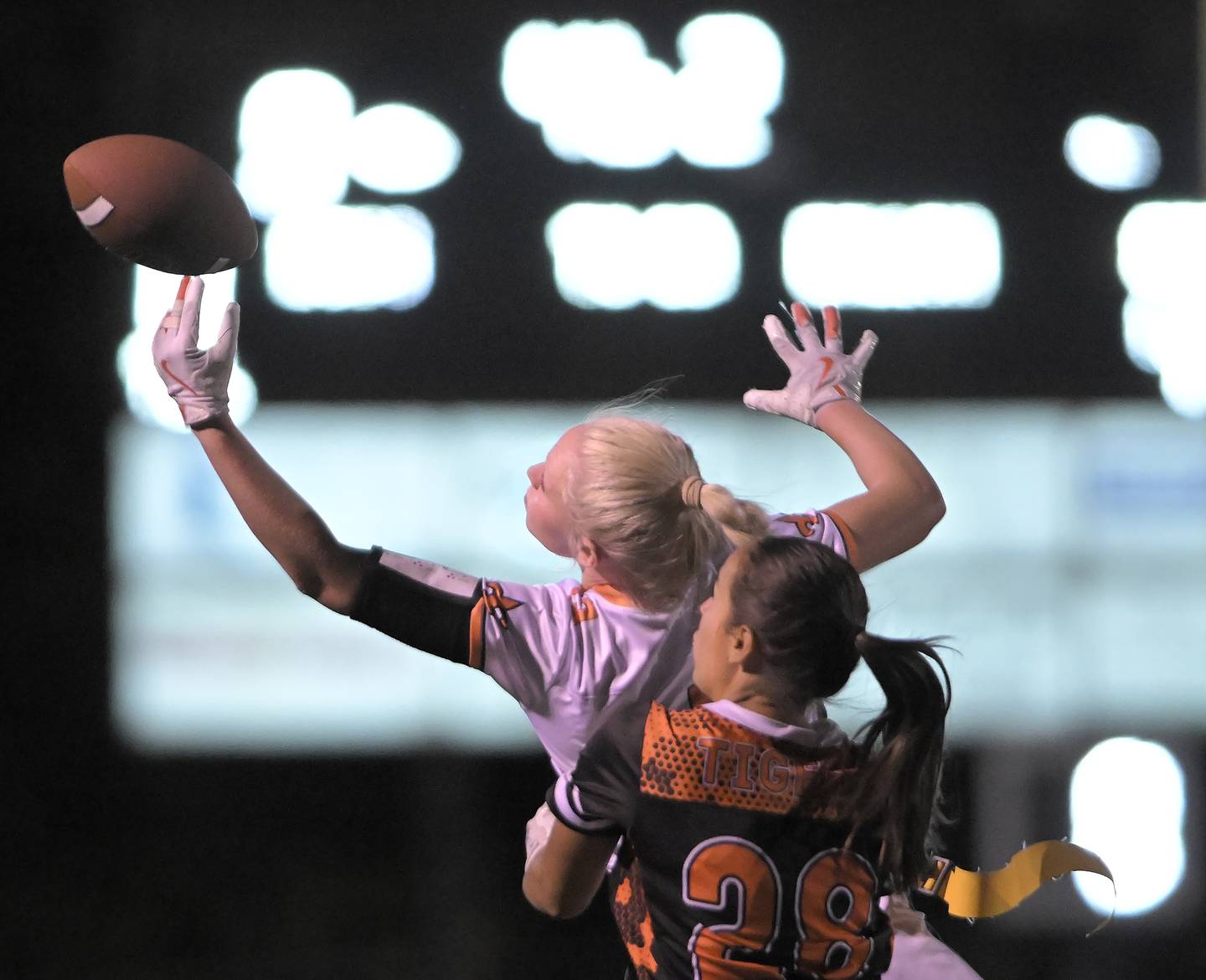 St. Charles East’s Addison Schilb stretches for an incomplete pass as Wheaton Warrenville South’s Alexia Escareno defends in a flag football game in Wheaton on Monday, Sept. 8, 2025.