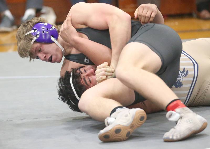 Dixon's Dawson Kemp wrestles Marquette's Alex Schaefer during the Class 1A Regional meet on Saturday, Jan. 31, 2026 at Princeton High School.