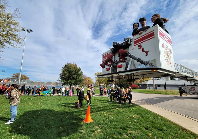 Participants in the Peru Halloween Celebration on Saturday at Washington Park take advantage of crane rides provided by the city's fire department.