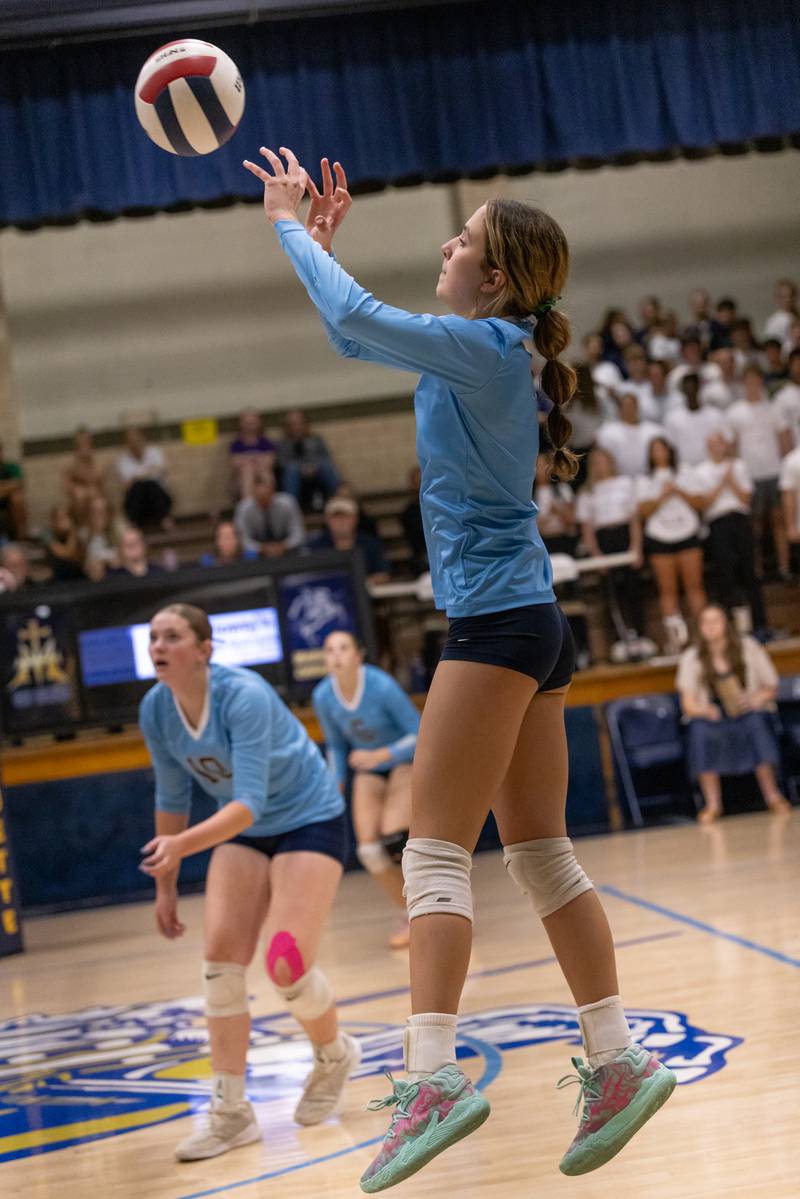 Kaitlyn Davis of Marquette sends a return shot over the net against Seneca High School during the match at Bader Gym on September 25, 2025 at Marquette High School.
