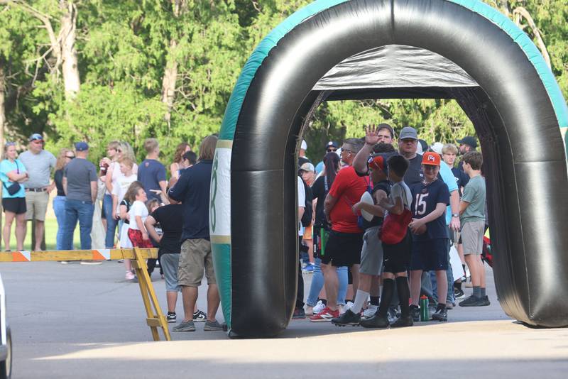 A long line of fans and kids wait for the gates to open during the Tyson Bagent Offensive Skills Camp on Saturday, May 23, 2026 at St Bede Academy.
