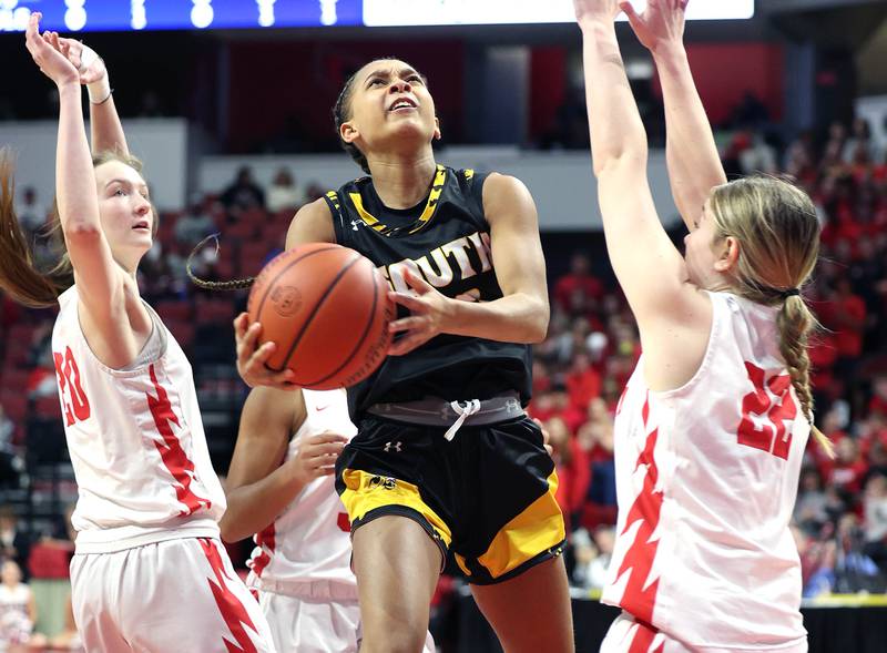 Hinsdale South's Hailey Goins goes to the basket between two Glenwood defenders during their game Friday, March 1, 2024, in the IHSA Class 3A state semifinal at the CEFCU Arena at Illinois State University in Normal.