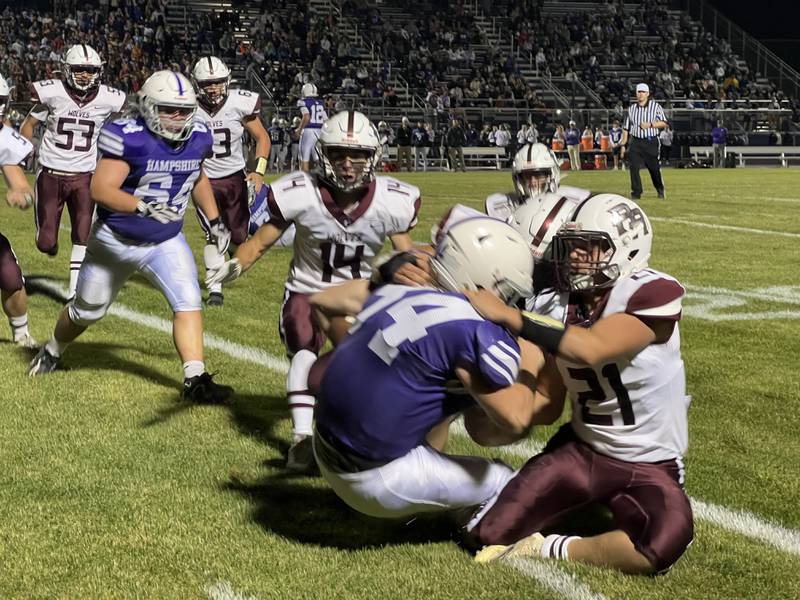 Prairie Ridge's  Jeffrey Emricson (21) and Nicholas Schones (14) close in defensively against Hampshire’s Cole Klawikowski during Friday's game in Hampshire.