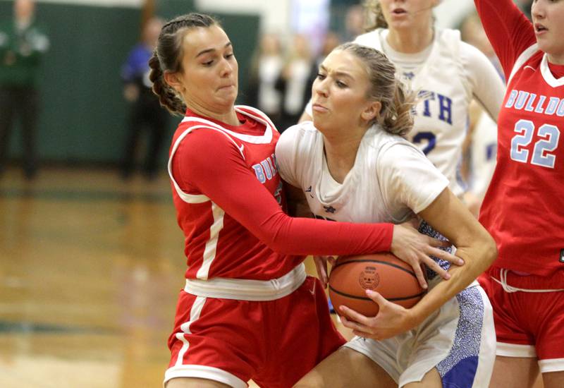 Batavia’s Brooke Carlson (left) battles St. Charles North’s Reagan Sipla for the ball during a Class 4A Glenbard West Sectional semifinal in Glen Ellyn on Tuesday, Feb. 21, 2023.