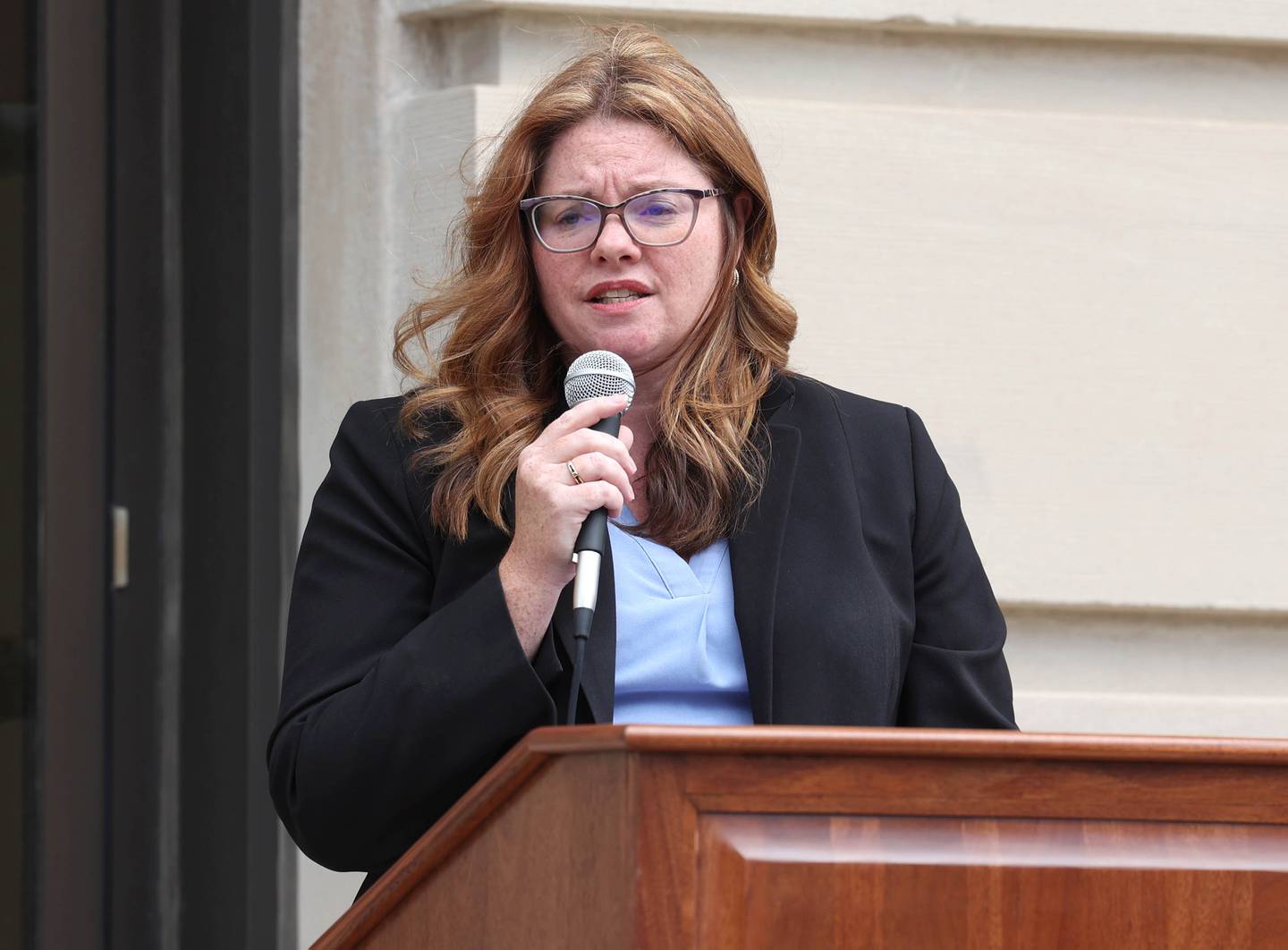 Sarah Gallagher Chami associate judge for the 23rd Judicial Circuit Court, speaks Tuesday, April 16, 2024, during the Hands Around the Courthouse event in front of the DeKalb County Courthouse in Sycamore. The event, hosted by CASA DeKalb County and Family Service Agency of DeKalb County, was held in honor of National Child Abuse Prevention Month.