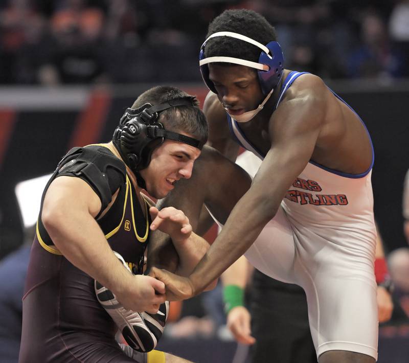 Montini’s Santino Tenuta, left, wrestles East St. Louis’s Pierre Walton in the Class 2A 165-pound final at the IHSA boys state wrestling championships at the State Farm Center in Champaign on Saturday, Feb. 22, 2025.