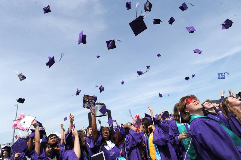 Graduates let their mortarboards fly during Plano High School's graduation ceremony on the football field, Sunday, May 19, 2024.