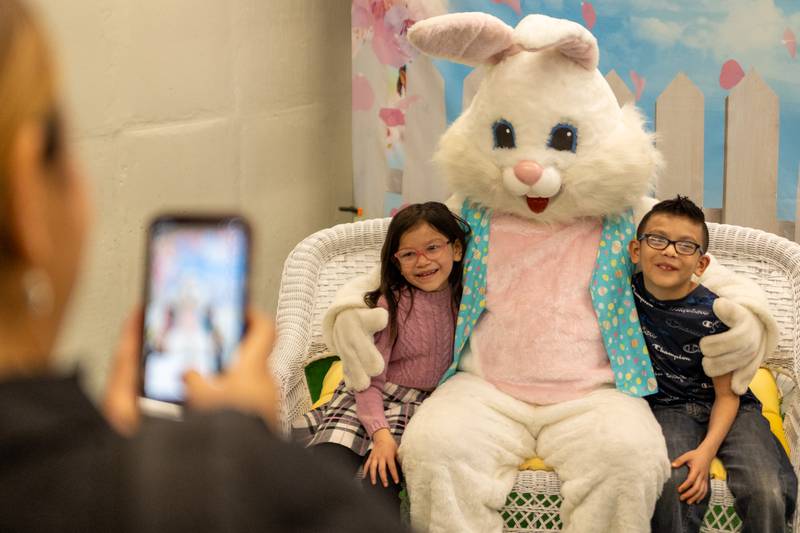 Kylie Gutierrez (left) and Martin Gutierrez (right) pose for photo with Easter bunny at the annual Easter Egg hunt on Saturday, April 12, 2025 at Hall High School in Spring Valley.