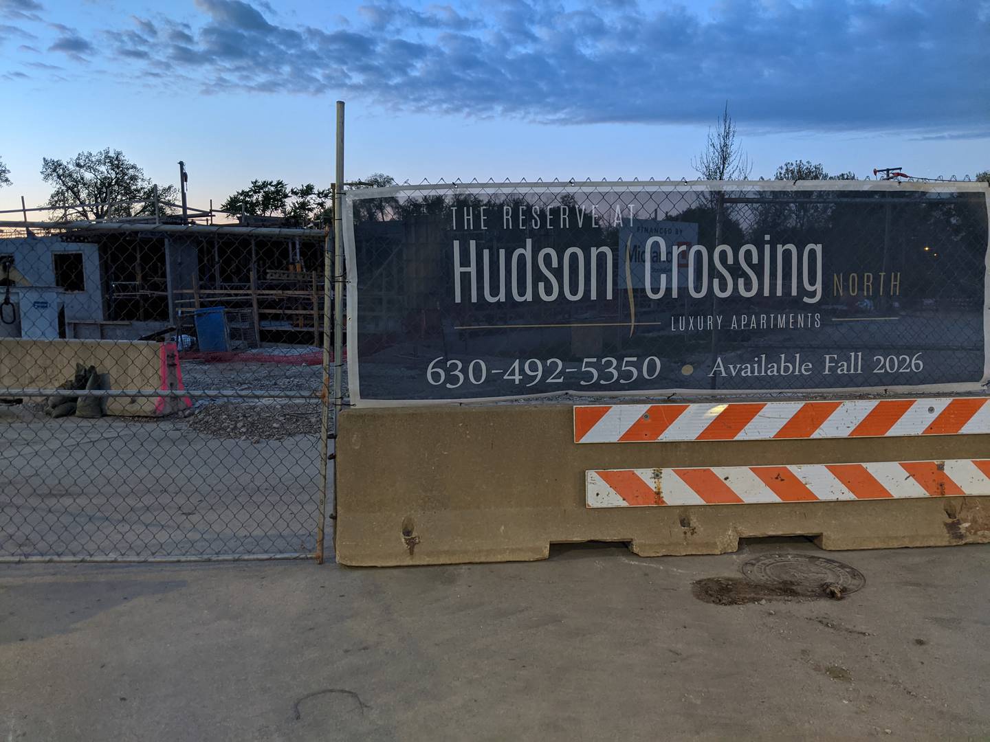 As work begins on the second building at Shodeen Group’s The Reserve at Hudson Crossing luxury apartment building in downtown Oswego, the village is selling $4.3 million in bonds that will fund a 123-space parking garage.
The village will take ownership of the parking garage after it is constructed. At a May 6 special Village Board meeting, village trustees unanimously approved selling bonds not to exceed $4.3 million.