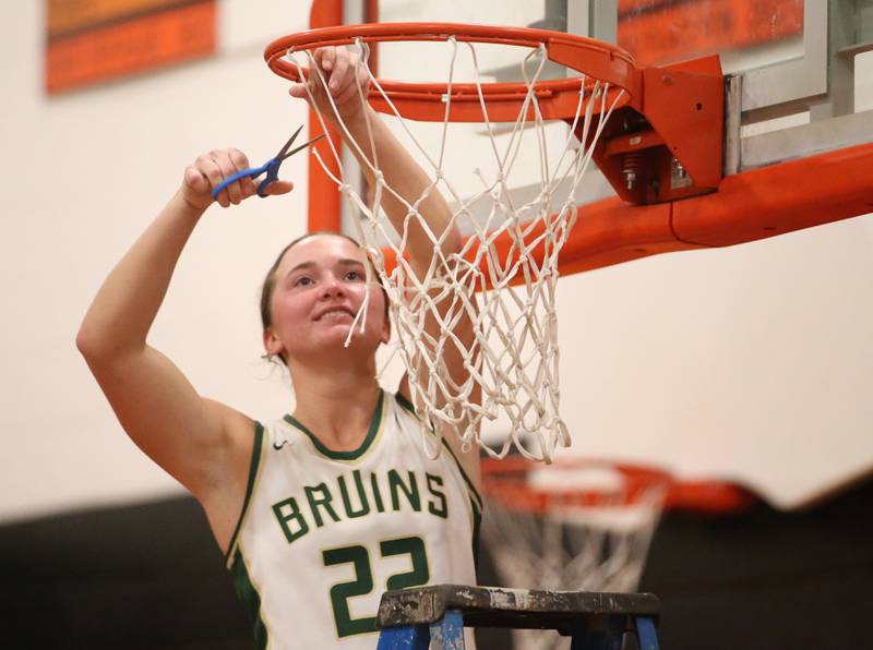 St. Bede's Ella Hermes smiles while cutting down a piece of the net after defeating Serena in the Class 1A Sectional final game on Thursday, Feb. 22, 2024 at Gardner-South Wilmington High School.