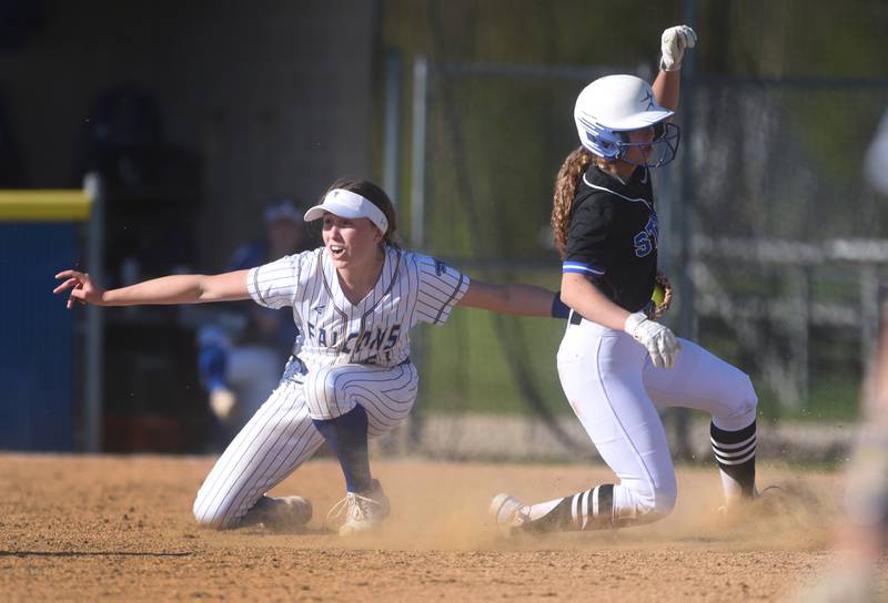 Wheaton North's Reagan Crosthwaite, left, tags out St. Charles North's Ginger Ritter at second base during Wednesday’s softball game in Wheaton.