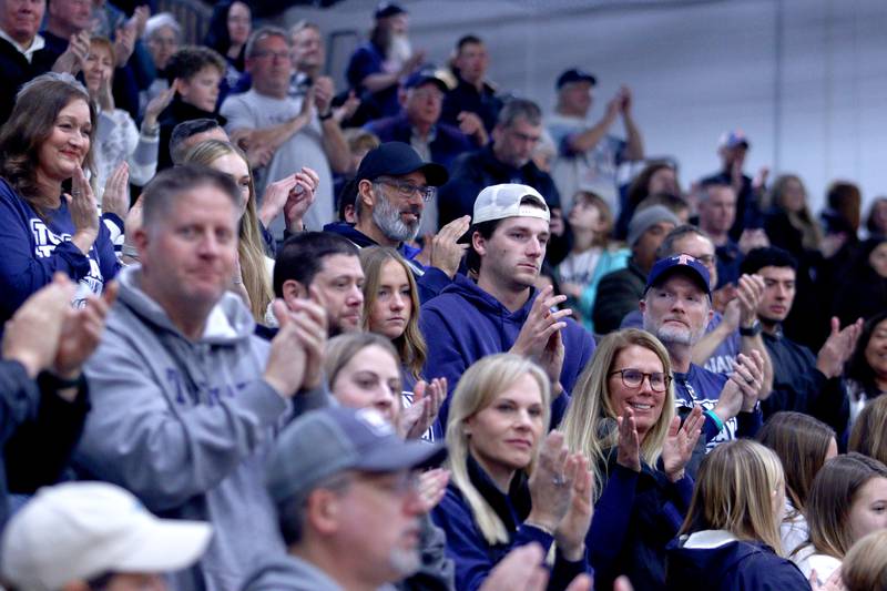 Community members acknowledge the Trojan players, coaches, and staff during a celebration of the IHSA Class 6A Champion Cary-Grove football team at the high school Sunday.