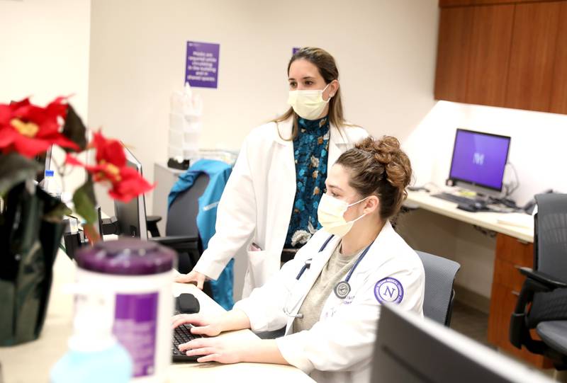Carla Cavallin (left) and Ischel Kelso, both in their second year in the Northwestern Medicine Delnor Hospital residency program, work in the program’s clinic on Thursday, Dec. 15, 2022 in Geneva.
