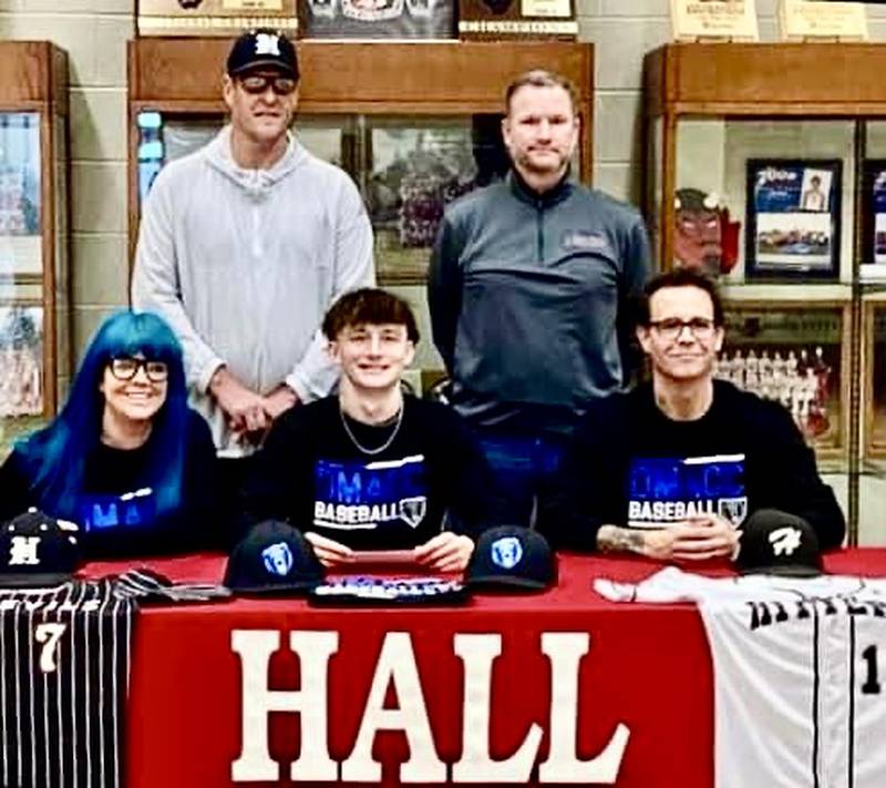 Hall senior Izzaq Zrust has signed to play baseball for Des Moines Area Community College. He was joined at his signing by his (front row) parents Amber and Zaq; and (back row) Hall coaches Matt McDonald and Tom Keegan.