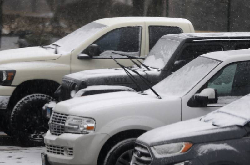 Snow starts to accumulate on vehicles parked in the parking lot of the McHenry City Hall have  on Wednesday, Feb. 12, 2025, in McHenry as a winter storm starts to bring heavy snow to the McHenry County area.