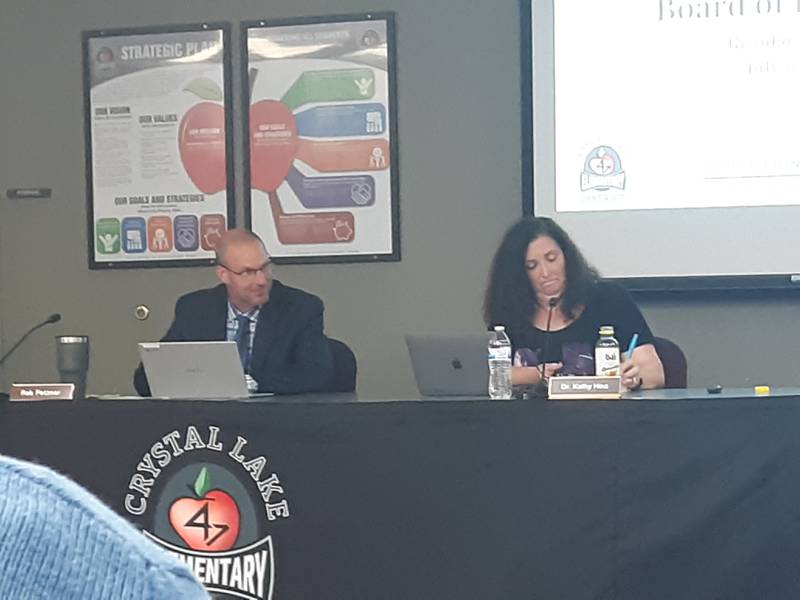 Crystal Lake Elementary School District 47 school Board President Rob Fetzner and Superintendent Kathy Hinz listen to public comment at a board meeting Monday, July 19, 2021.