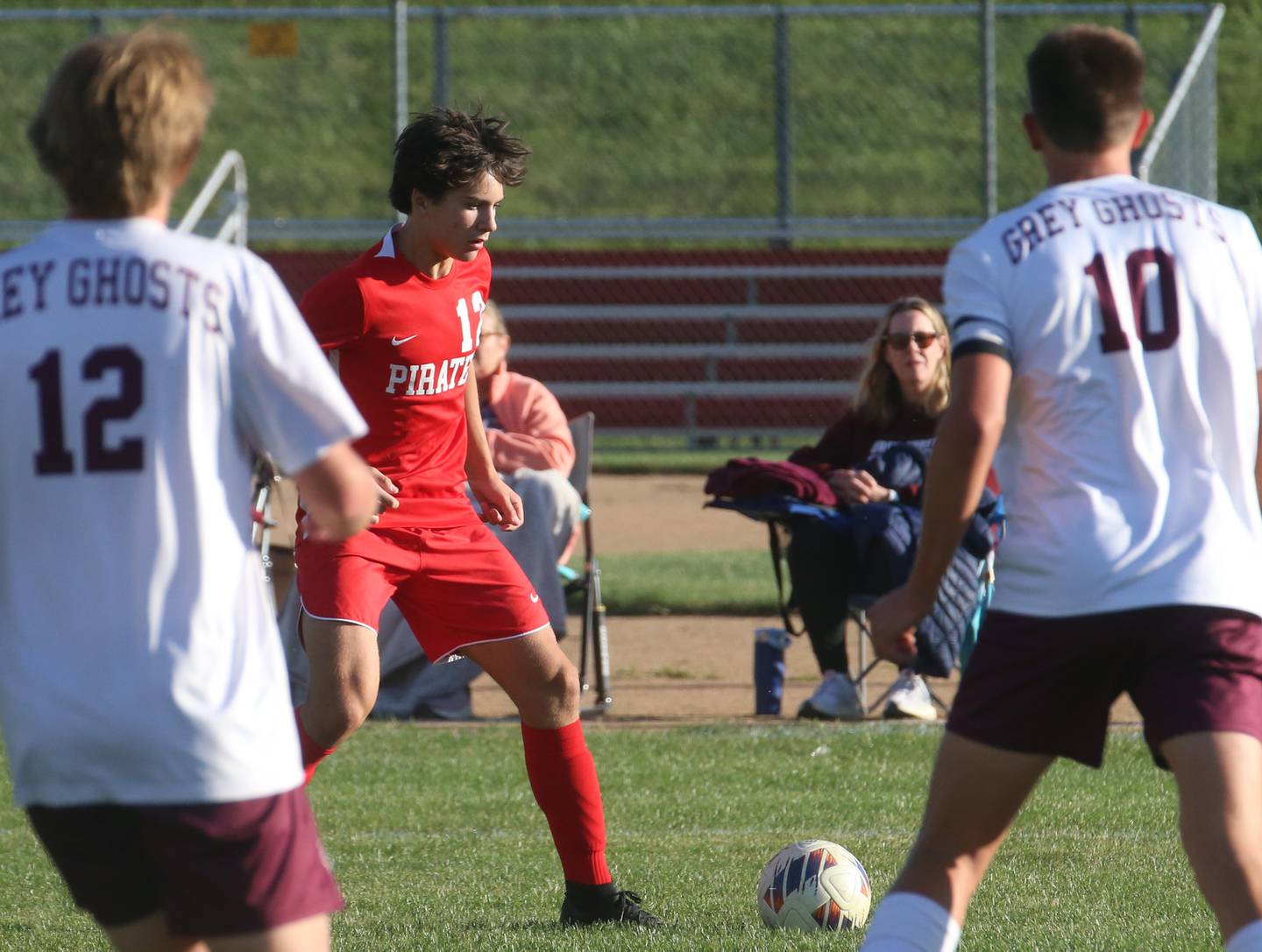 Ottawa's Alexio Fernandez kicks the ball past Illlinois Valley Central's John Urbanc and teammate Grant Bramer