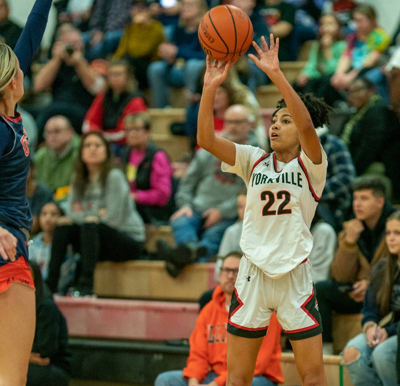 Yorkville's Alexandra Stewart (22) shoots a three-pointer against Oswego during the 13th annual Hoops 4 Hope Communities vs. Cancer basketball event at Yorkville High School on Saturday, Jan 28, 2023.