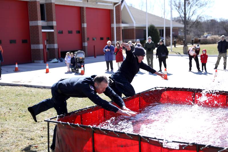 Wheaton Police detectives Greg Hayward and Nadia Duarte take the plunge during the Wheaton Police Department’s annual polar plunge to benefit Illinois Special Olympics on Saturday, March 22, 2025 at the Wheaton Fire Department.