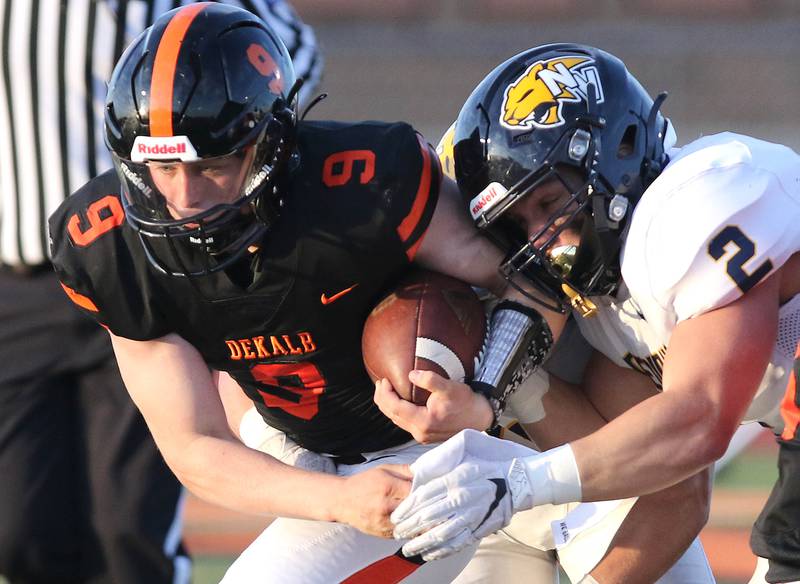 DeKalb running back Tucker Ikens tries to get free from Nequa Valley's Trey Borske during their game Friday, April 16, 2021, at DeKalb High School.