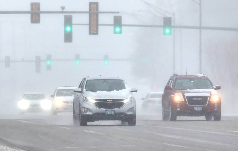 Vehicles make their way through the sleet and snow Thursday, Feb. 16, 2023, on Sycamore Road in DeKalb. Winter weather and icy roads caused travel difficulties in DeKalb County Thursday.
