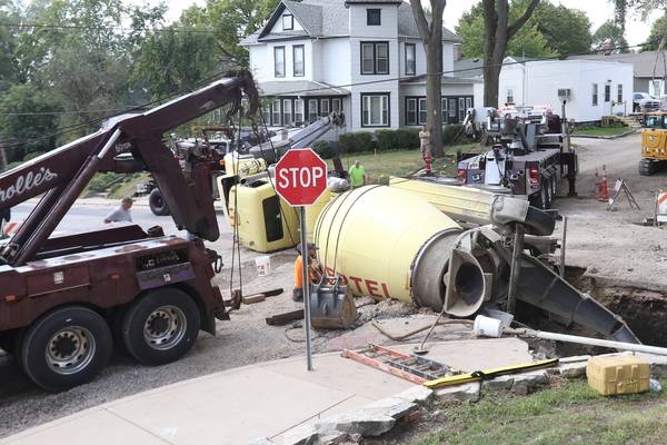 Photos: Cement truck falls into sinkhole in Peru