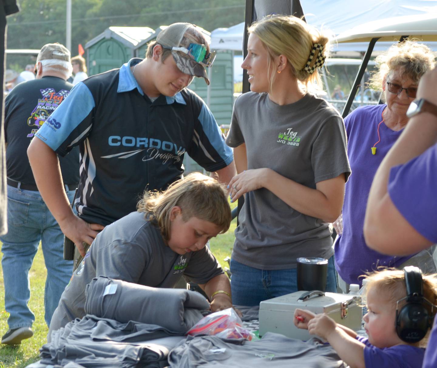 Jeg Weets, 9, of Morrison, autographs a shirt for Cordova Dragway employee Michael Smit of Rock Falls while he talks to Jenna Weets, Jeg’s mom. Jeg was the 2022 Grand Marshal for the World Series and was represented by Jeg Weets Racing.