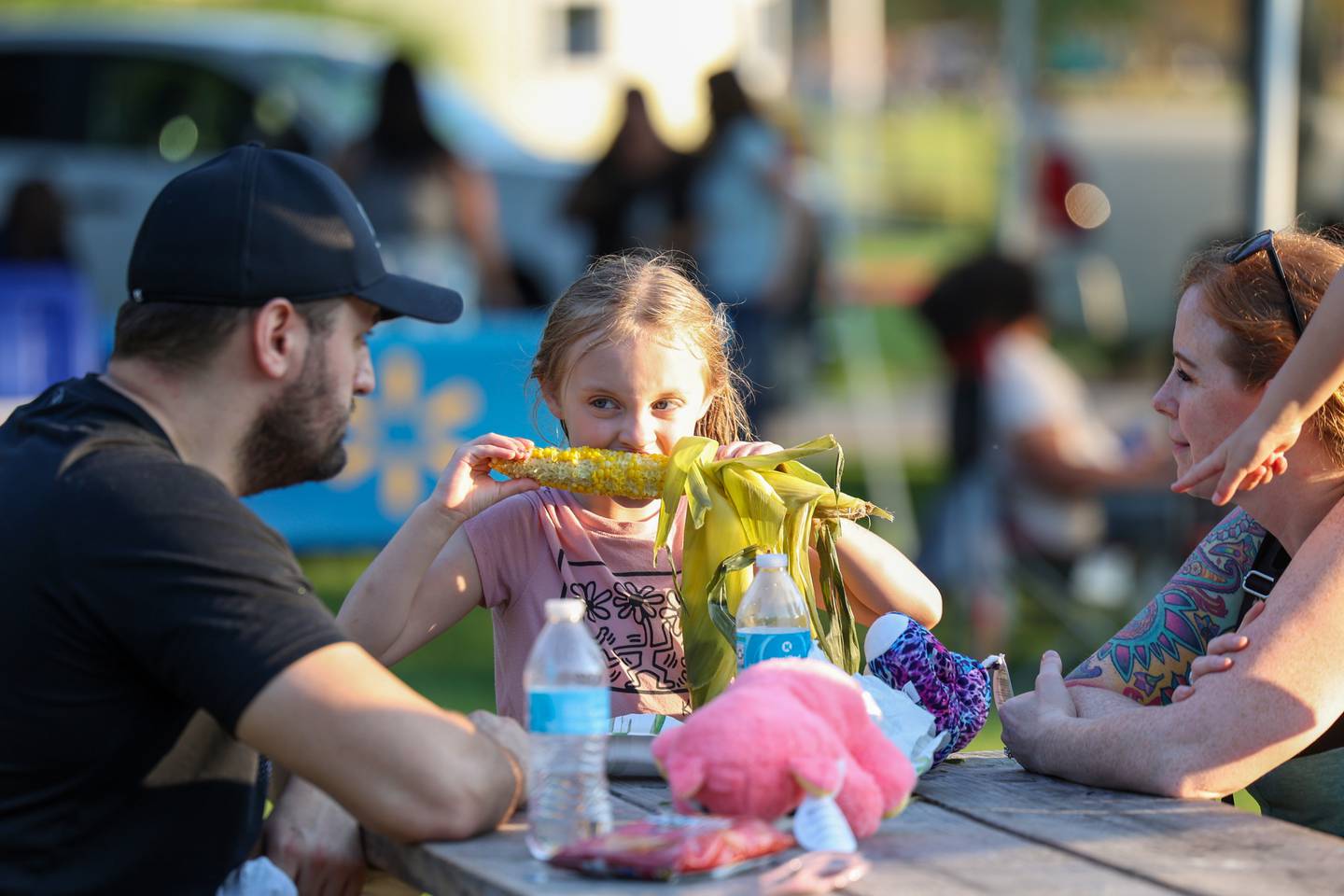 Adalyn Zandy, 5, of Bradley, takes a bite of sweet corn during National Night Out at Perry Farm Park in Bradley on Tuesday, Aug. 5, 2025.