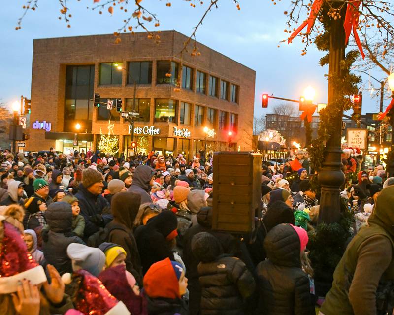 A small section Infront of the train station on Main Street in Downers Grove on Friday Nov. 29, 2024, packed community members who came out to watch the Christmas tree lighting ceremony take place.