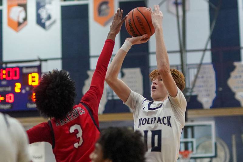 Oswego East's Noah Mason (10) shoots the ball over West Aurora's Jayvyn Marion (3) during a basketball game at Oswego High School on Friday, Feb 2, 2024.