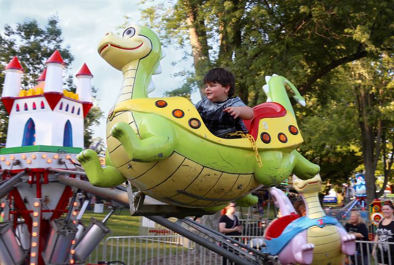Three-year-old Jackson Oliver of Aurora rides on a dragon ride at Montgomery Fest on Friday, Aug. 15, 2025.
