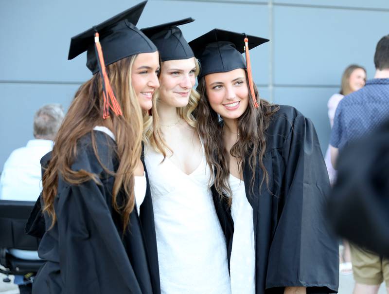 (Left to right) St. Charles East graduates Ava Rosenberg, Hannah Nelson and Emily Bremer pose for a photo before the school’s 2023 commencement ceremony at Northern Illinois University in DeKalb on Monday, May 22, 2023.