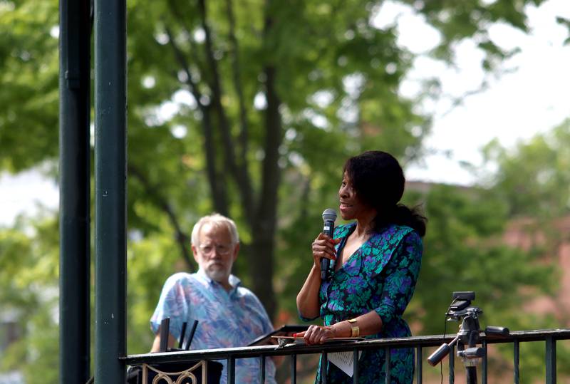 Gloria Van Hof of Crystal Lake greets people during McHenry County’s 2nd Annual Juneteenth Festival at the Woodstock Square Saturday.