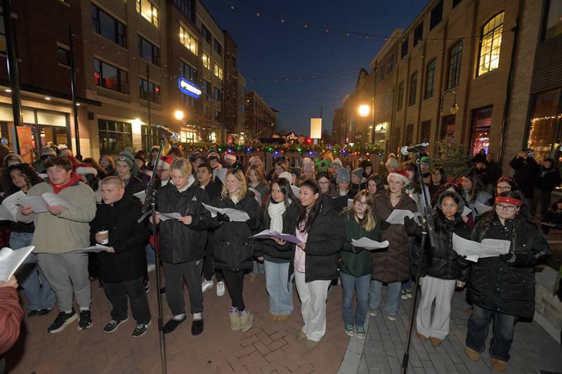 St. Charles North and East High School Choirs sing carols during the Lighting of the Lights Ceremony at 1st Street Plaza on Friday, Nov 28, 2025 in St. Charles.