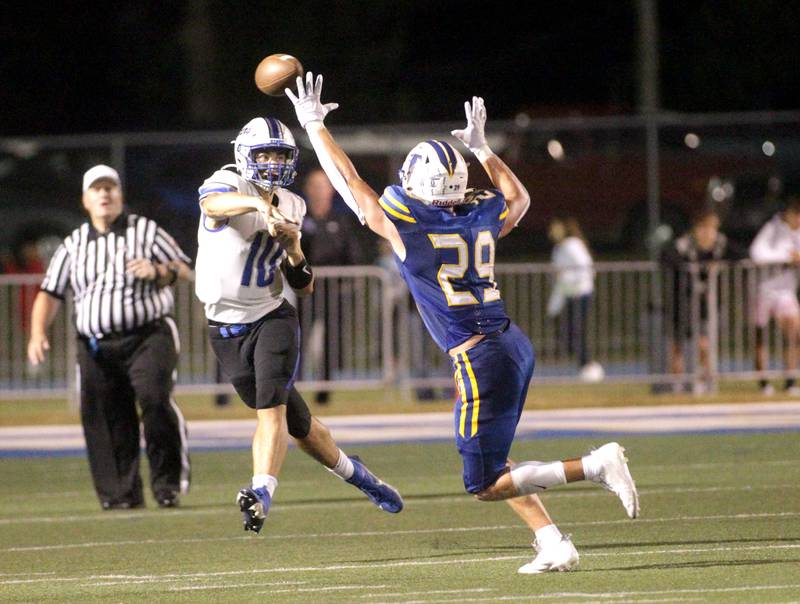 St. Charles North quarterback Ethan Plumb passes the ball over Wheaton North’s Walker Owens during a game in Wheaton on Friday, Sept. 8, 2023.
