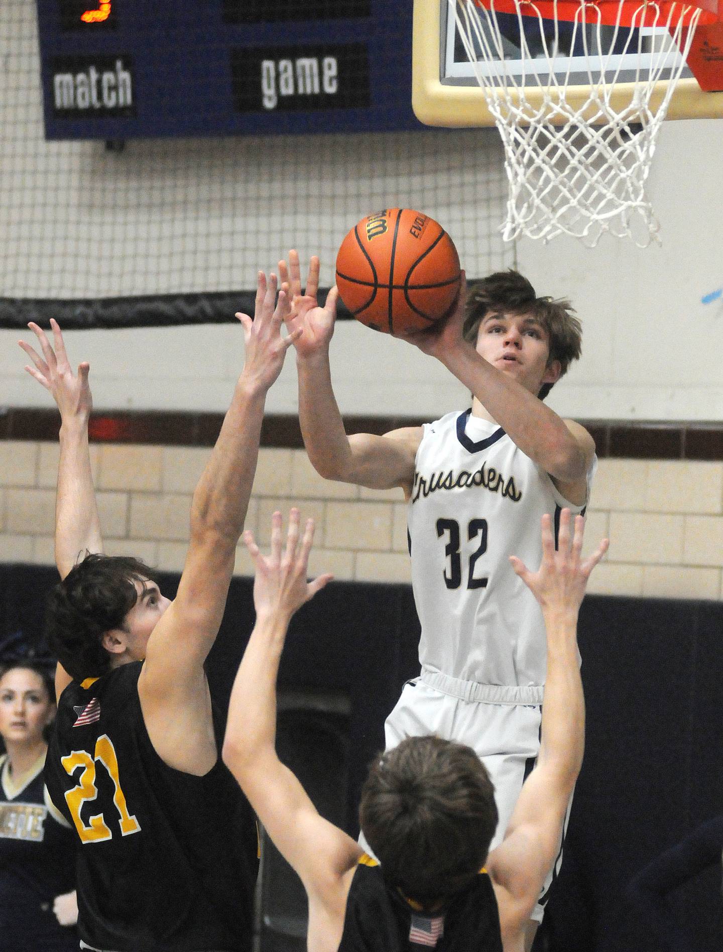 Marquette's Charlie Mullen shoots past the defense of Putnam County's Orlando Harris (21) and Blake Billups at Bader Gymnasium on Friday, Feb. 3, 2023.