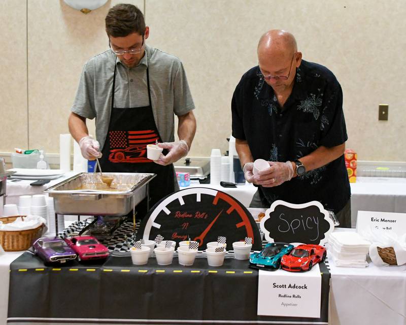 Scott Adcock, left, and his dad Roy Adcock prepare samples of their dish before the start of the 21st annual CASA DeKalb County's Men Who Cook fundraiser on Saturday, Aug. 9, 2025, held at Northern Illinois University's Barsema Alumni and Visitors Center.