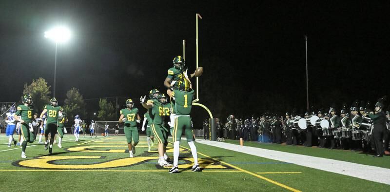 Fremd’s Davyn Kuhl lifts teammate Jayden Faulkner after his second quarter touchdown run against Hoffman Estates in a football game in Palatine on Friday, Sept. 27, 2024.