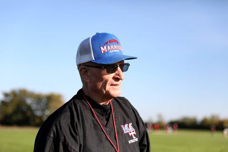 Former U.S. Marine Mark Placey works with the Marmion Academy football offensive line during a recent practice in Aurora.