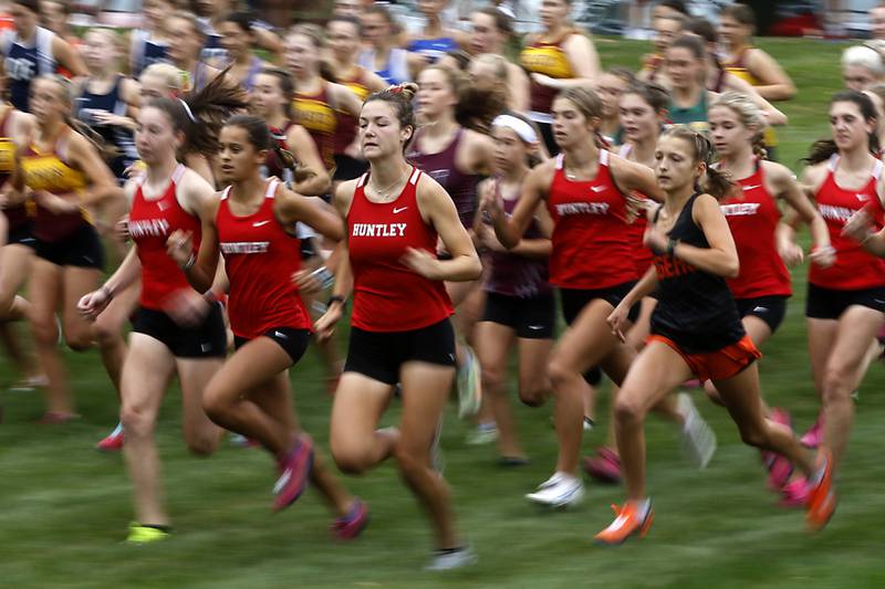Huntley’s Morgan Sauber, Haley Rahman, and Ava Allison get out to a quick start during the girls race of the McHenry County Cross Country Meet Saturday, August 27, 2022, at Emricson Park in Woodstock.