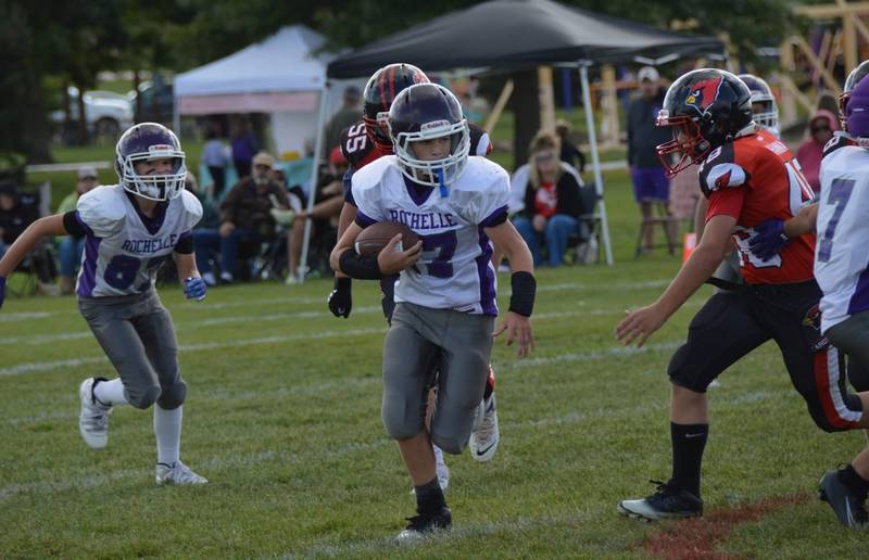 Rochelle's Grant Rowley breaks through three defenders for a 15-yard gain during a sixth-grade junior tackle football game with Stillman Valley on Sunday, Sept. 7, 2025. Rochelle won the game 30-0.