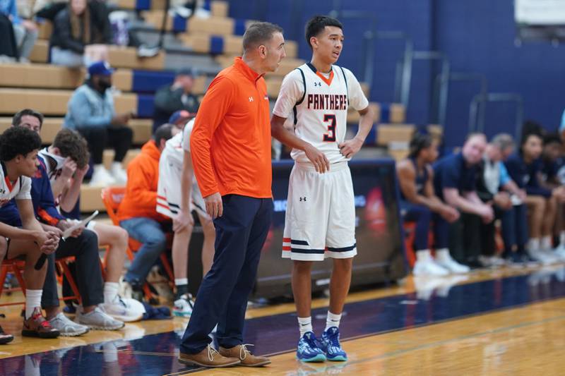 Oswego’s head coach Nick Oraham gives instructions to Ethan Vahl (3) against Rockford Guilford during a hoops for healing basketball tournament game at Oswego on Monday, Nov. 25, 2024.
