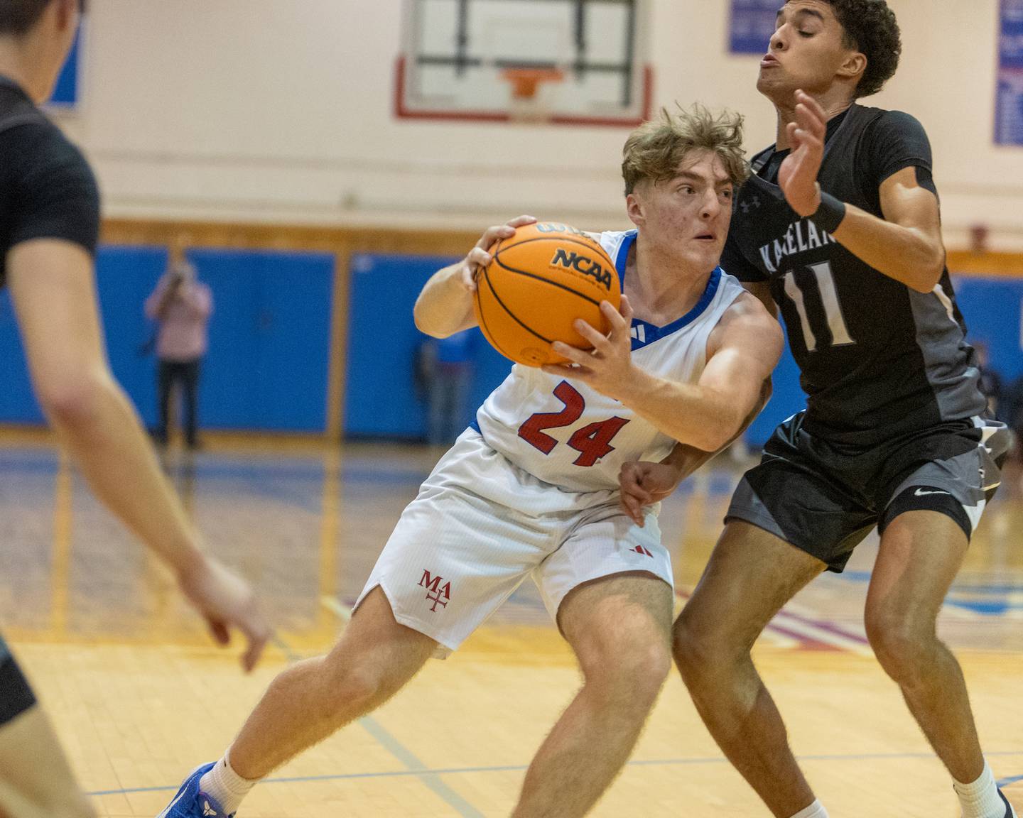 Marmion's Joseph Kramer drives to the basket against Kaneland's Evan Frieders on Wednesday, Dec.17,2025 in Aurora.