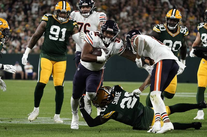 Chicago Bears running back David Montgomery runs from Green Bay Packers safety Darnell Savage during the first half, Sunday, Sept. 18, 2022, in Green Bay, Wis.