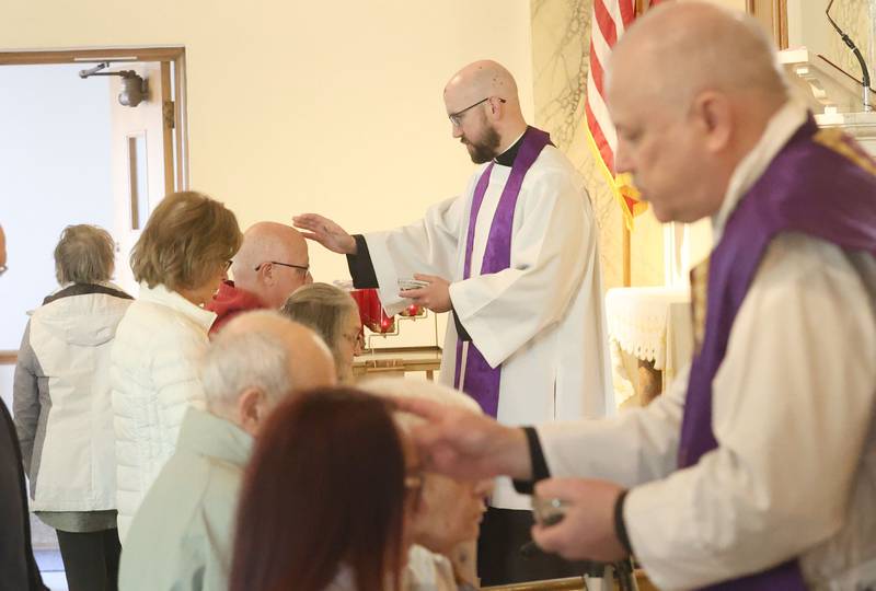 Rev. Tom Otto and Rev. J.A Small,  distribute ashes during Ash Wednesday Mass on Wednesday, Feb. 18, 2026 atThe Queen of the Holy Rosary Memorial Shrine in La Salle. Ash Wednesday marks the beginning of Lent eading up to observances of Jesus' death on Good Friday and resurrection on Easter.