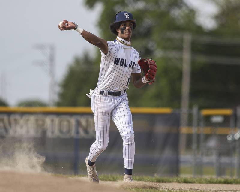Oswego East's Jacsen Tucker (17) throws across the field to first after fielding a grounder during baseball game between Oswego East at Oswego. Monday, May 19, 2025 in Oswego.